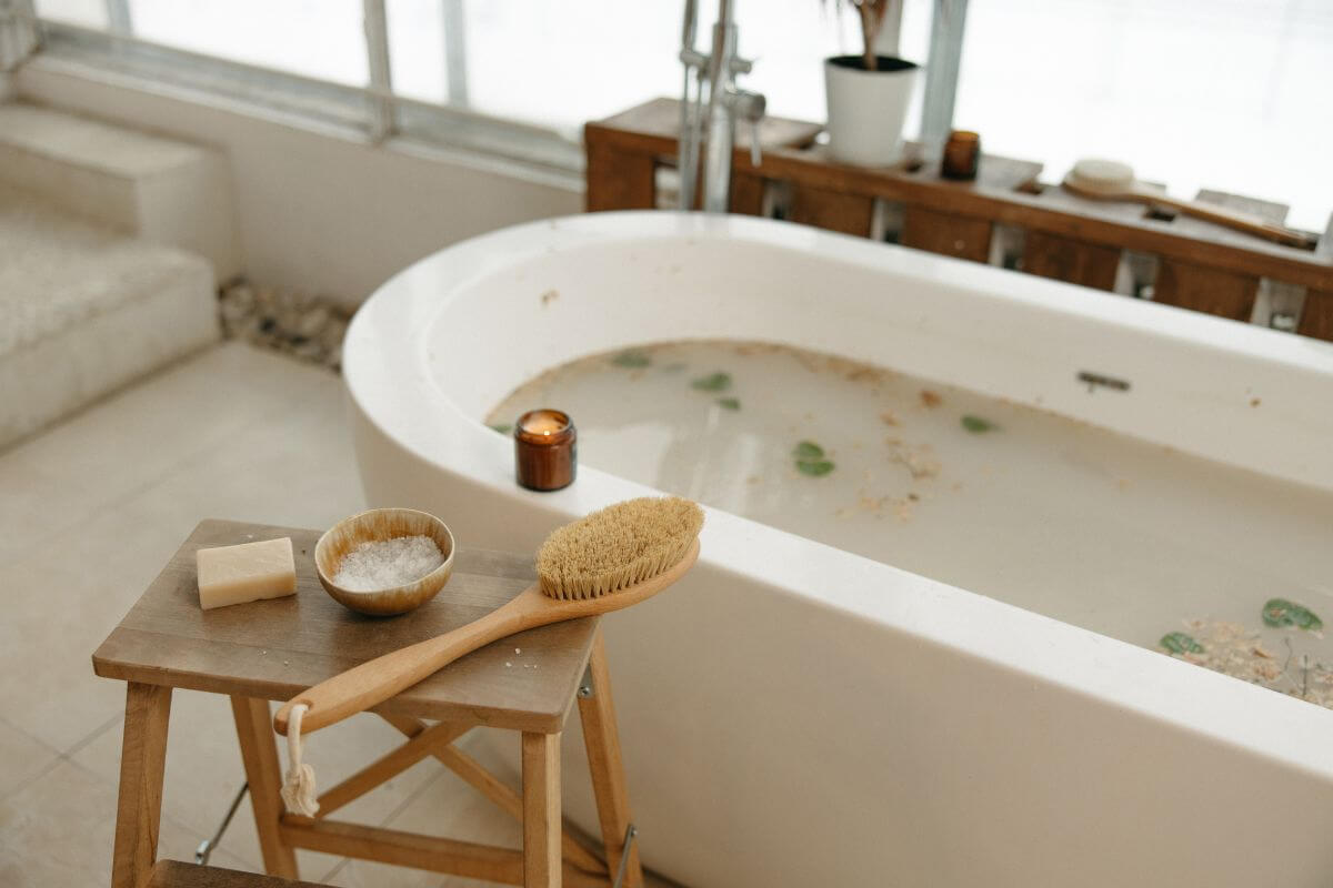 A white bathtub filled with water and Epsom salt